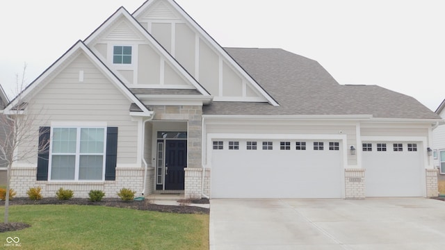 tudor home with a garage and a front yard