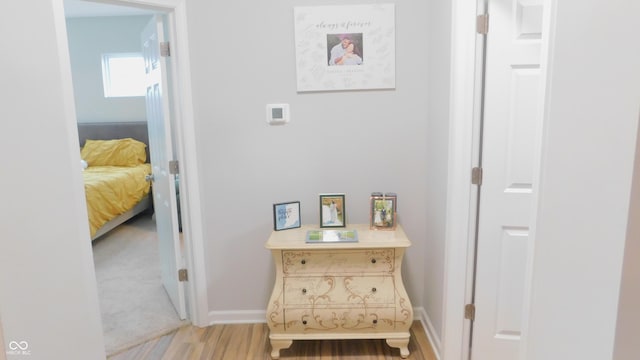 corridor with hardwood / wood-style floors