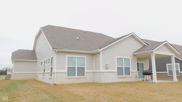 back of property featuring a lawn