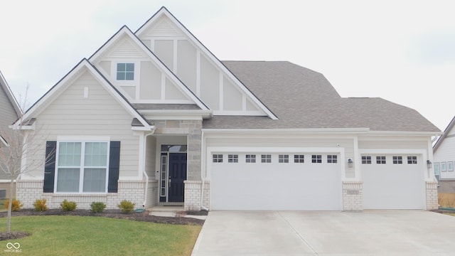 tudor home with a garage and a front lawn