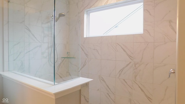 bathroom with a tile shower