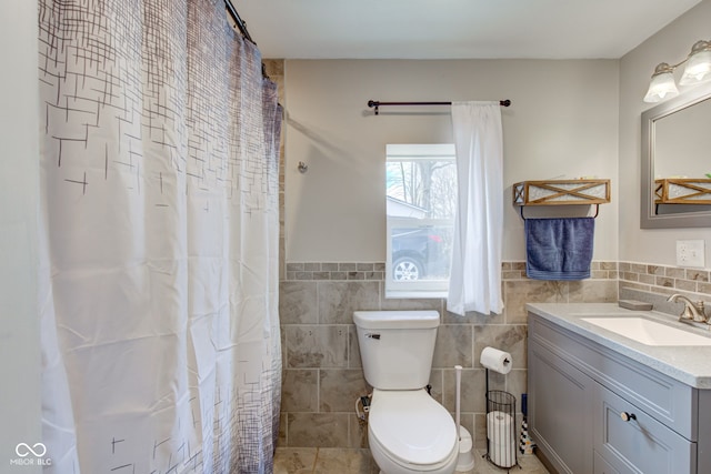 bathroom featuring tile walls, vanity, a shower with curtain, and toilet