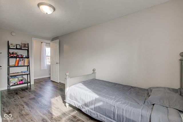 bedroom featuring hardwood / wood-style flooring and a textured ceiling