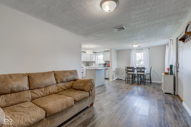 living room with hardwood / wood-style flooring and a textured ceiling