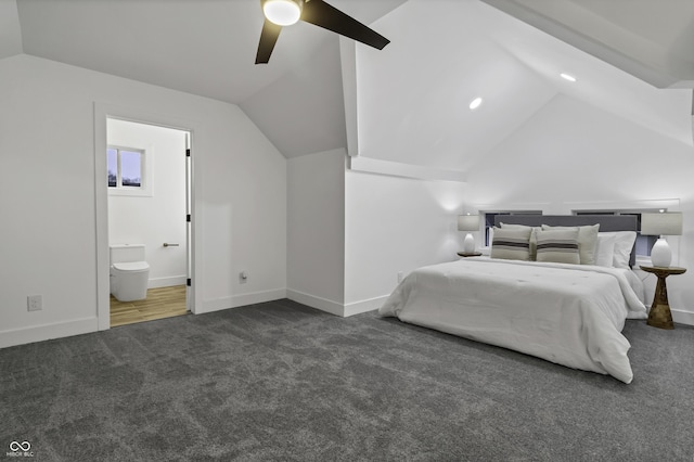 unfurnished bedroom with connected bathroom, vaulted ceiling, ceiling fan, and dark colored carpet