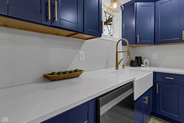 kitchen with blue cabinets, dishwasher, sink, and backsplash