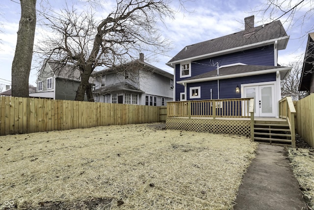 back of house with french doors and a deck