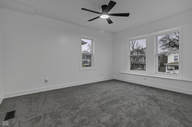 carpeted spare room with ceiling fan