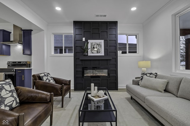 living room featuring ornamental molding and a fireplace