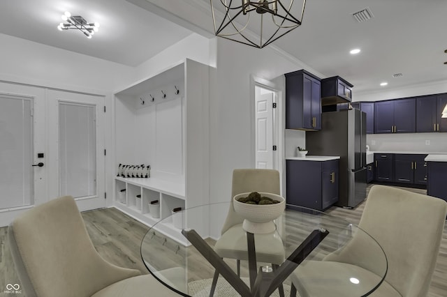 mudroom with crown molding and light wood-type flooring