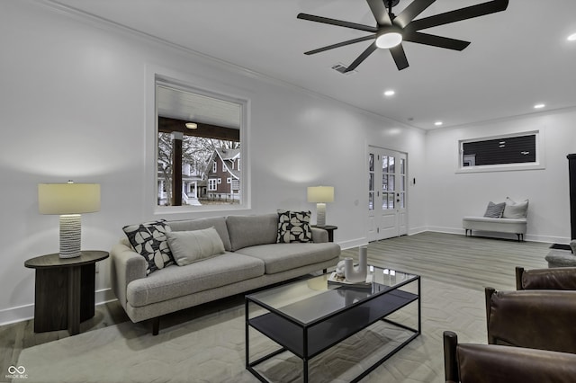 living room featuring crown molding, ceiling fan, and hardwood / wood-style flooring