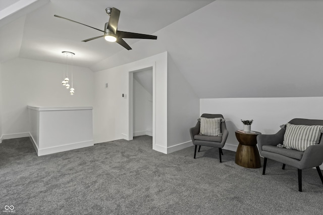 living area featuring lofted ceiling and dark carpet