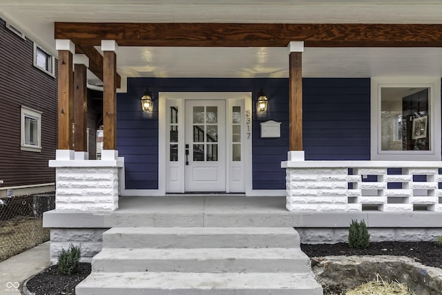 entrance to property featuring a porch