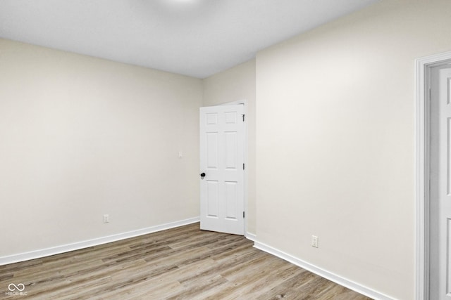 spare room featuring light hardwood / wood-style flooring