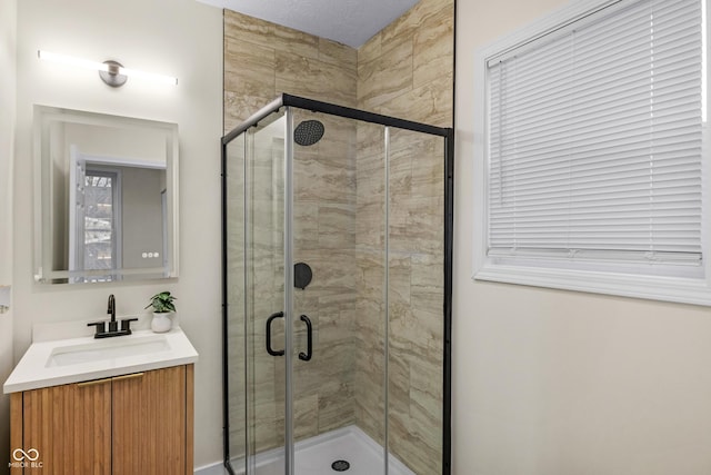 bathroom with vanity and a shower with shower door