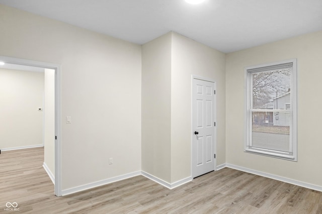 empty room with light hardwood / wood-style flooring