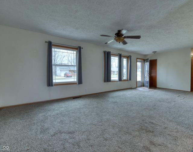 spare room with ceiling fan, carpet flooring, and a textured ceiling