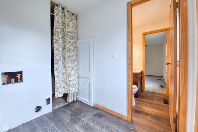 laundry room featuring washer hookup and dark hardwood / wood-style flooring