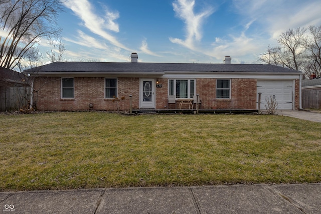 single story home featuring a garage and a front lawn