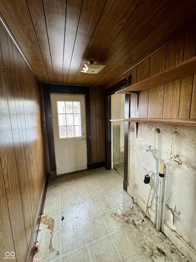 laundry room featuring wood ceiling and wooden walls