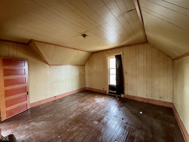 bonus room featuring lofted ceiling, dark hardwood / wood-style floors, and wood walls