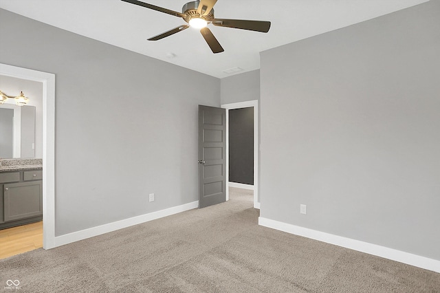 unfurnished room featuring ceiling fan and light colored carpet