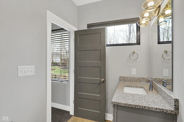 bathroom with vanity and an inviting chandelier