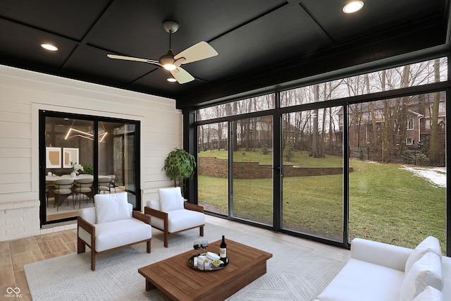 sunroom / solarium with plenty of natural light, coffered ceiling, and ceiling fan