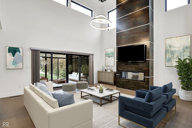 living room featuring wood-type flooring and a high ceiling