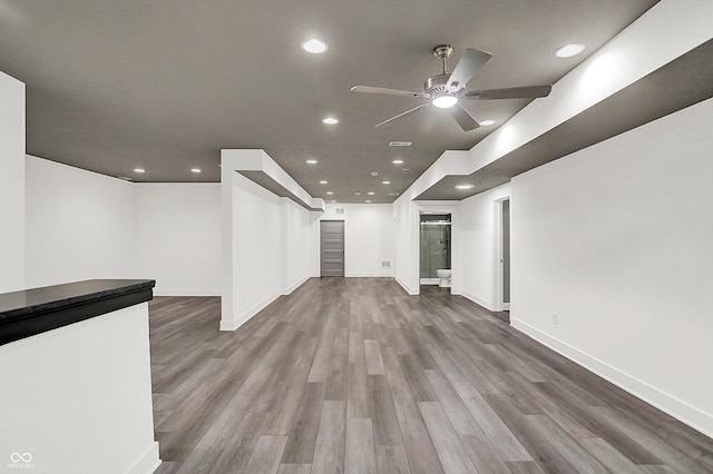 interior space with wood-type flooring and ceiling fan