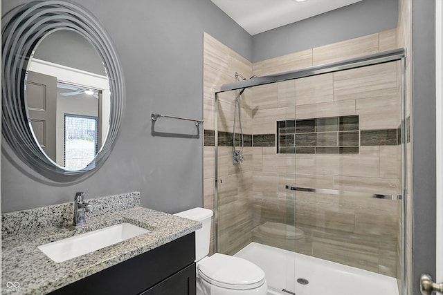 bathroom with vanity, an enclosed shower, and toilet