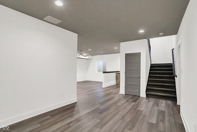 unfurnished living room featuring hardwood / wood-style flooring and ceiling fan