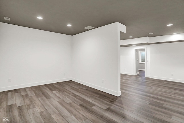 unfurnished room with dark wood-type flooring