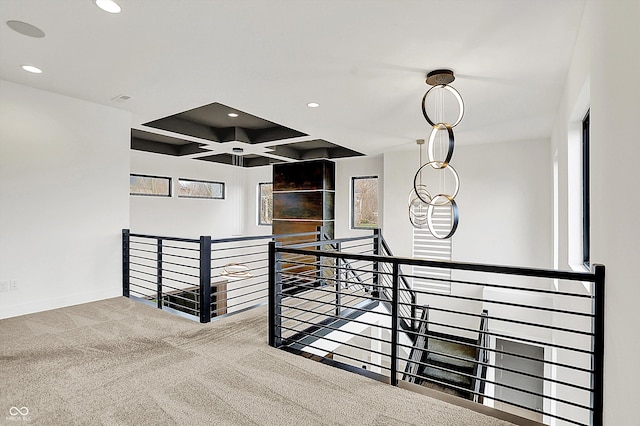 hallway featuring coffered ceiling and carpet floors