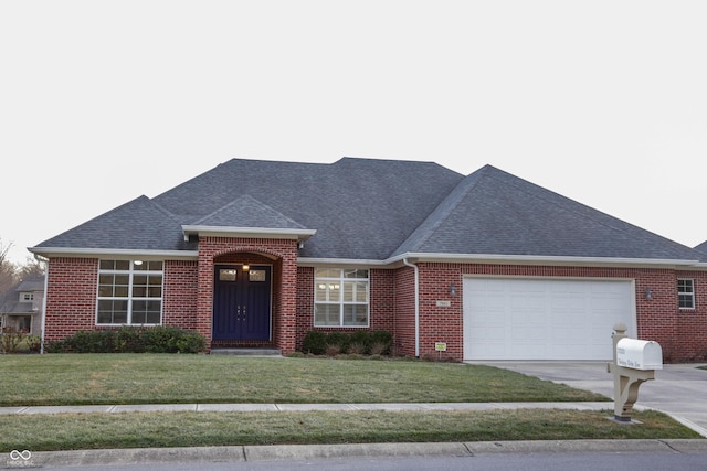 single story home featuring a garage and a front lawn