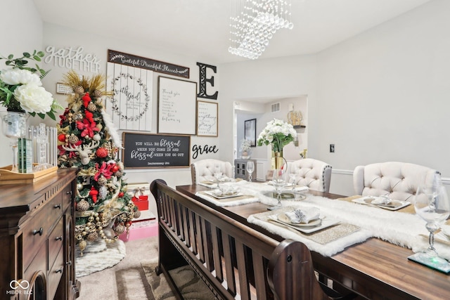 dining room with an inviting chandelier and carpet