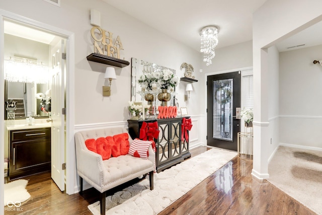 entrance foyer featuring dark wood-type flooring and a chandelier