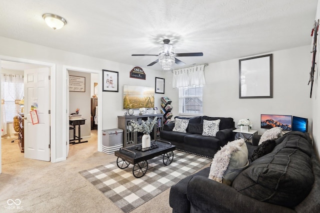 carpeted living room with ceiling fan and a textured ceiling