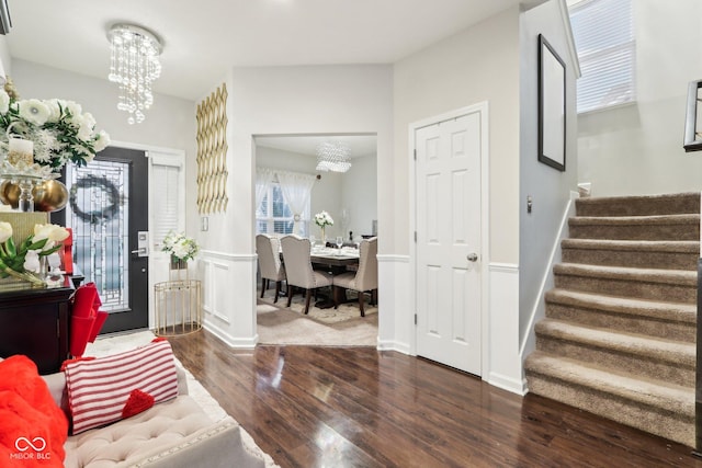 foyer featuring a notable chandelier and dark hardwood / wood-style flooring