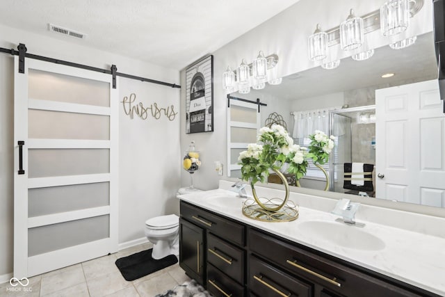 bathroom featuring vanity, toilet, tile patterned floors, and a shower with shower door