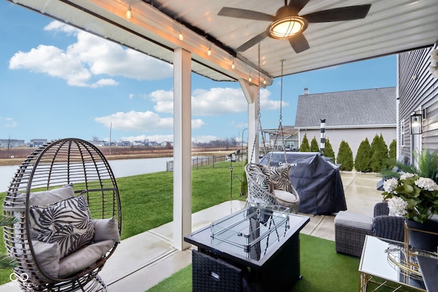 sunroom with a water view and ceiling fan