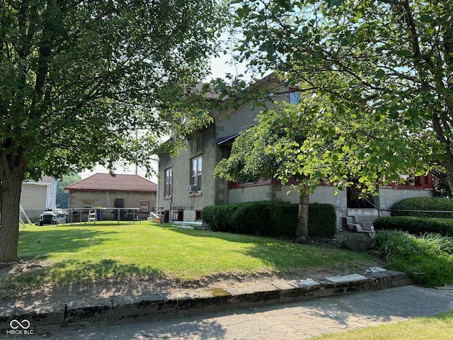 obstructed view of property featuring a front yard