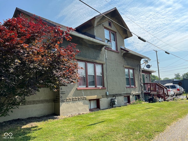 view of side of property with a yard