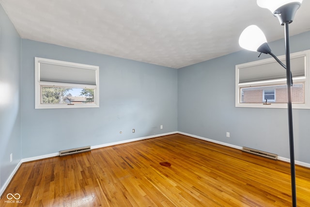 empty room featuring wood-type flooring