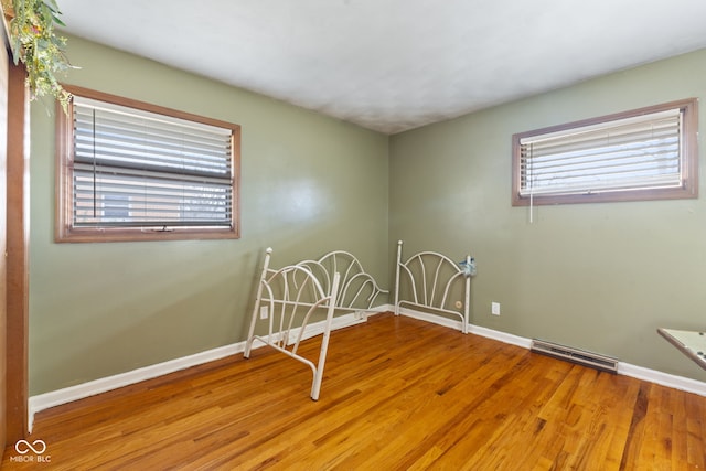 empty room with hardwood / wood-style flooring