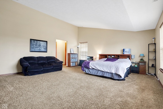 bedroom featuring carpet flooring, high vaulted ceiling, and a textured ceiling