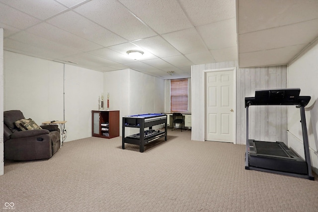 exercise room featuring carpet floors and a paneled ceiling