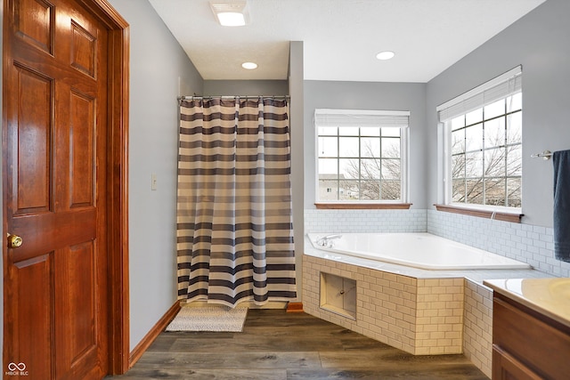 bathroom with independent shower and bath and hardwood / wood-style floors