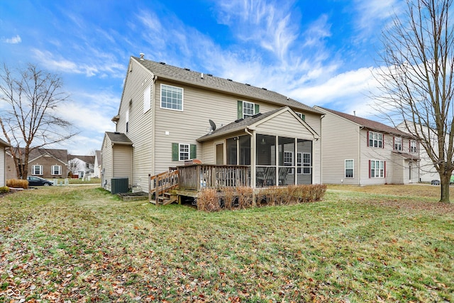 rear view of house with central AC unit, a yard, a sunroom, and a deck