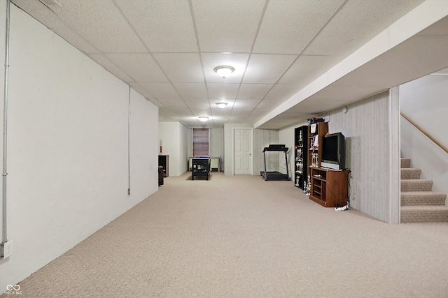 basement with carpet and a paneled ceiling